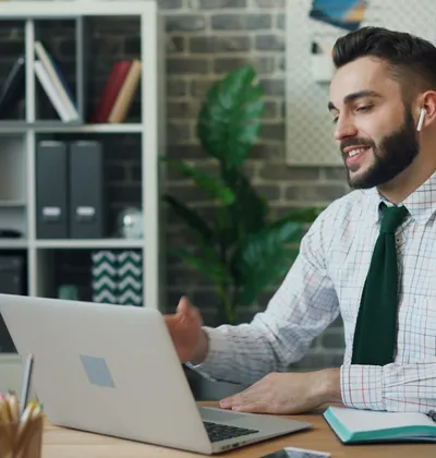 Small-business owner reviewing his software subscriptions on a laptop