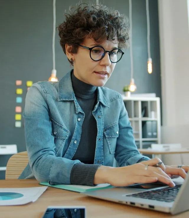 Entrepreneur working through an automation workflow on her laptop